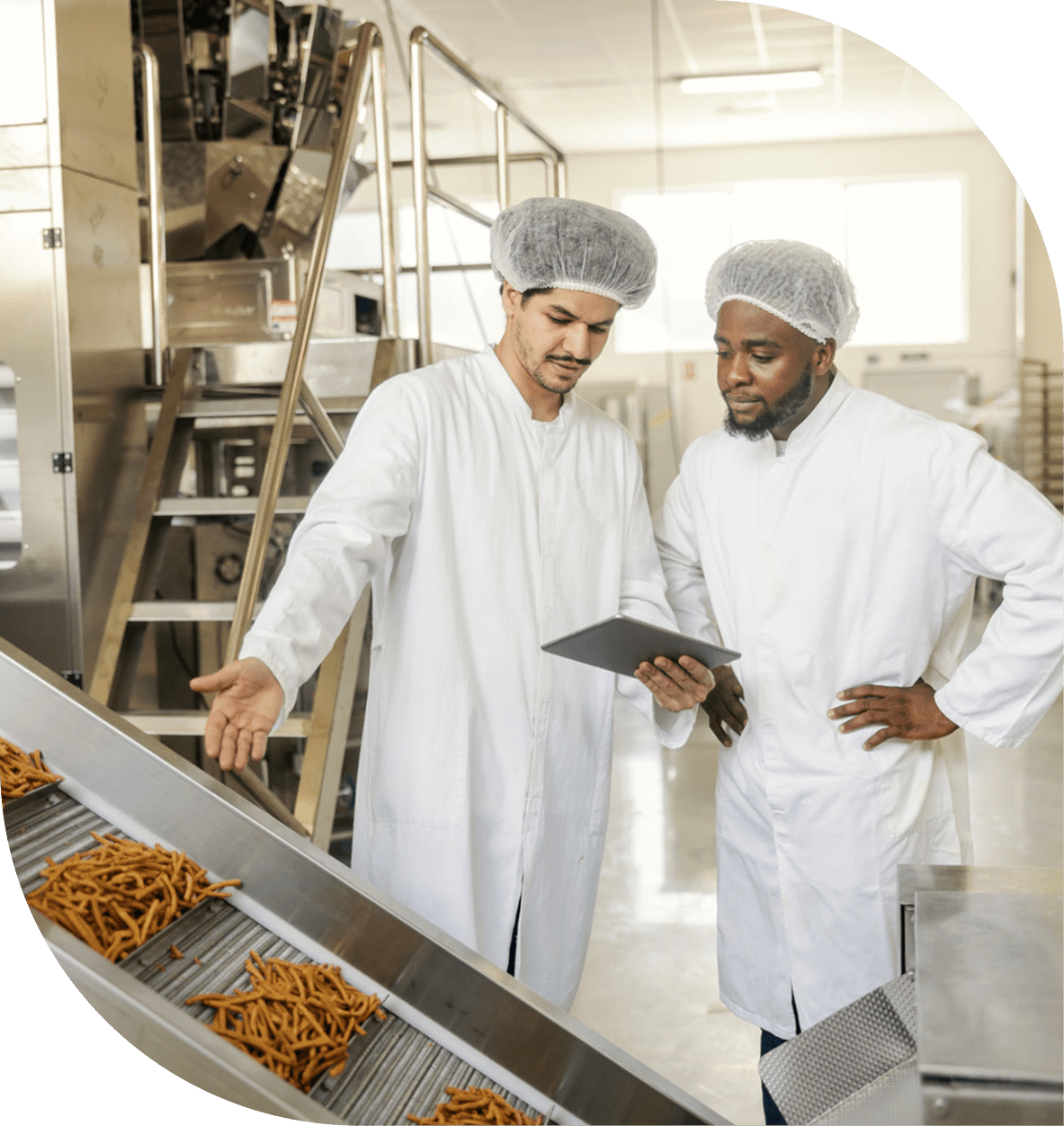 Factory workers inspecting pasta on conveyor belt.