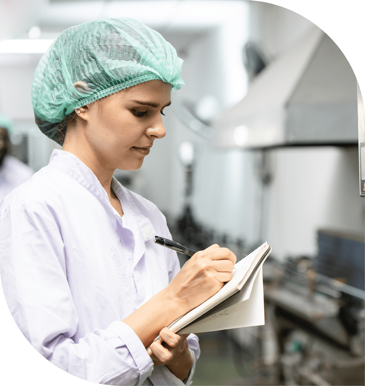 Woman in lab coat writing notes.